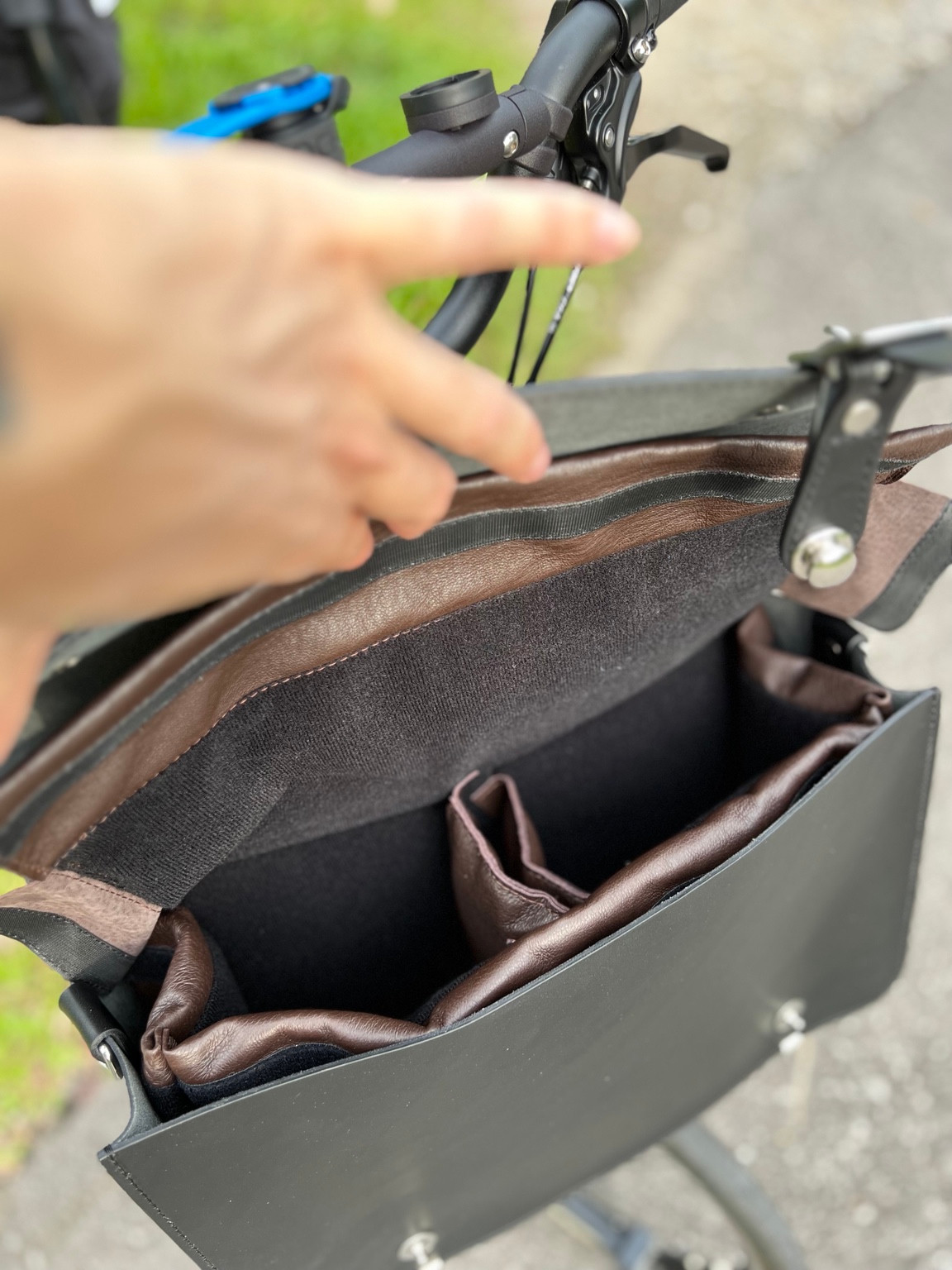 Open black Souma Leather camera bag showing the brown padded insert