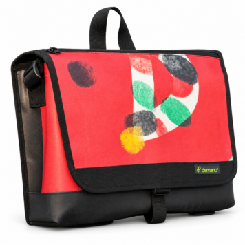 Demano Arago 1712 red Brompton medium front bag with an off-white curve and multicoloured fingerprint-style circles, black trim and sewn Demano label, isolated on white.