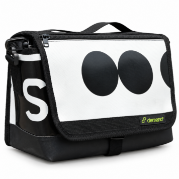 Demano Ribera 1709 Brompton mini front bag with bold charcoal circles on a white flap, cropped white lettering on black panels and black trim, isolated on white.