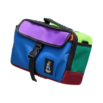 Valeria’s Barcelona Cris Mini 5L Brompton bag, Colour Block #01, with blue front, purple flap, green sides and burgundy base on white