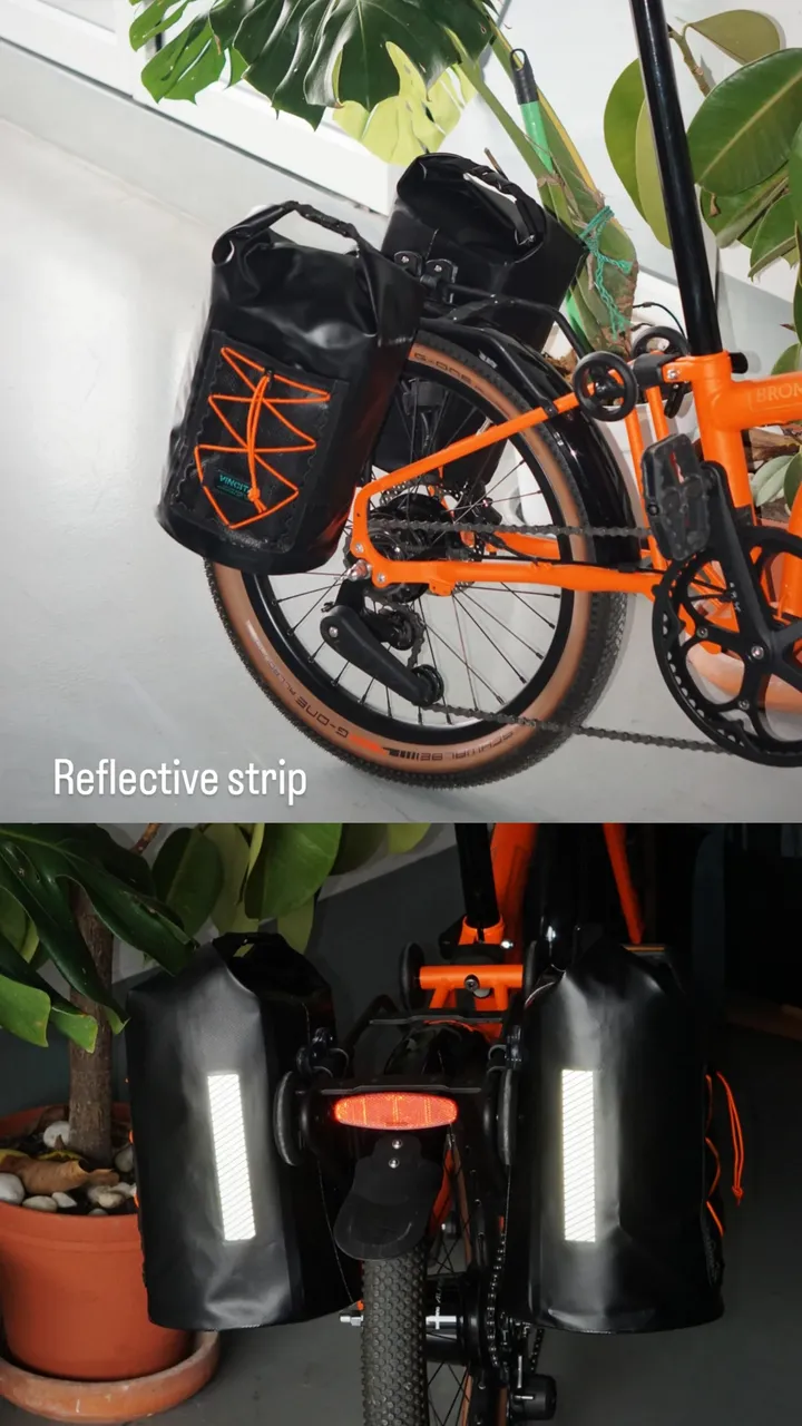Vincita Orbit left and right panniers mounted on an orange bicycle, showing reflective strips